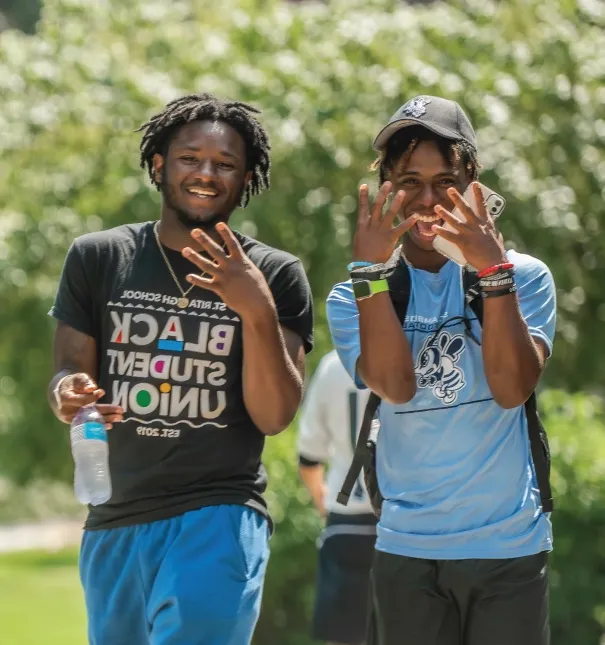 Two students walking outdoors on the first day of classes.